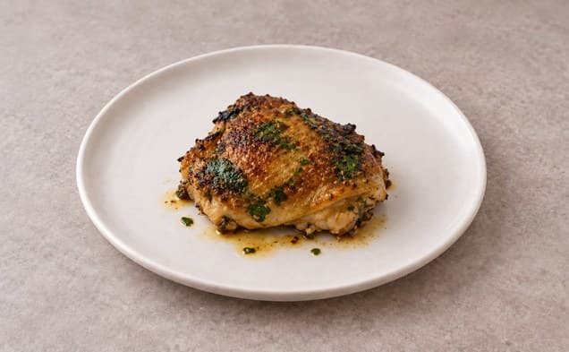 Glazed marinated chicken thighs on a plate