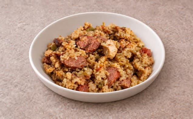A serving of chicken jambalaya on a plain white dish